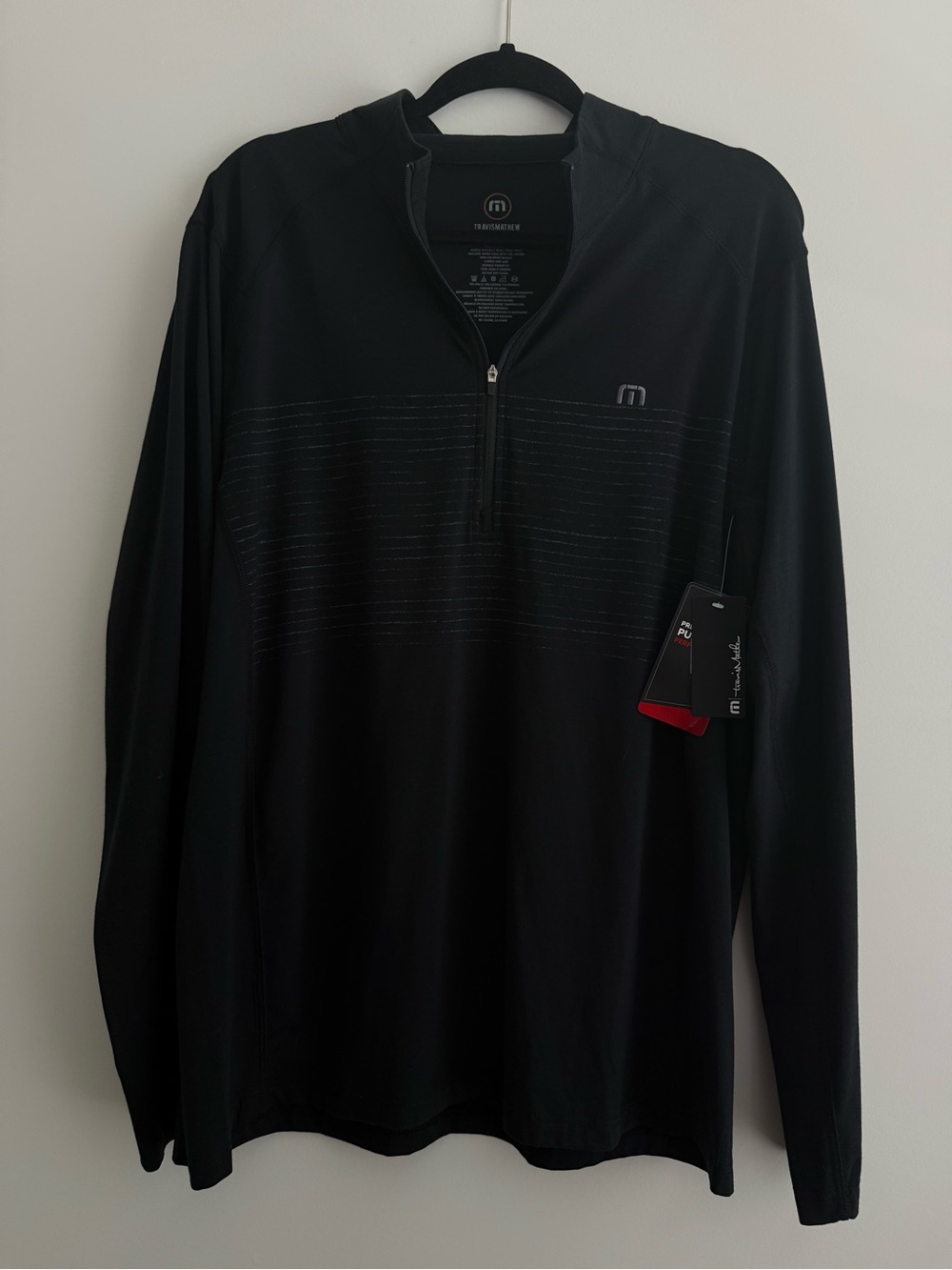 Travis Mathew Black Quarter-Zip Pullover with Subtle Stripe Accents